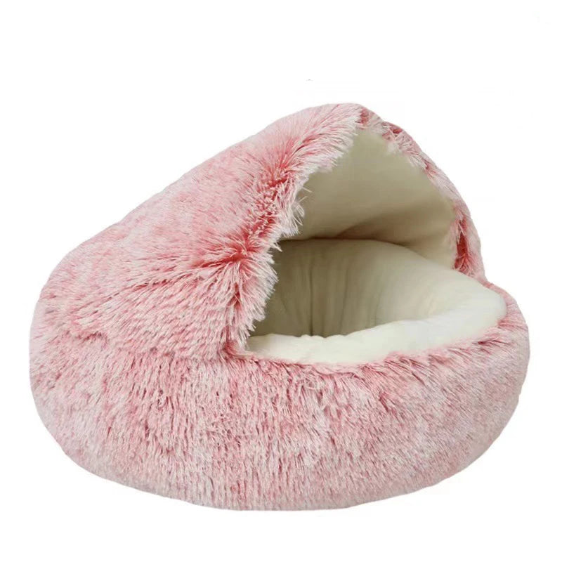 A round pink plush pet bed with a removable white cover, showing the soft, fluffy texture inside.