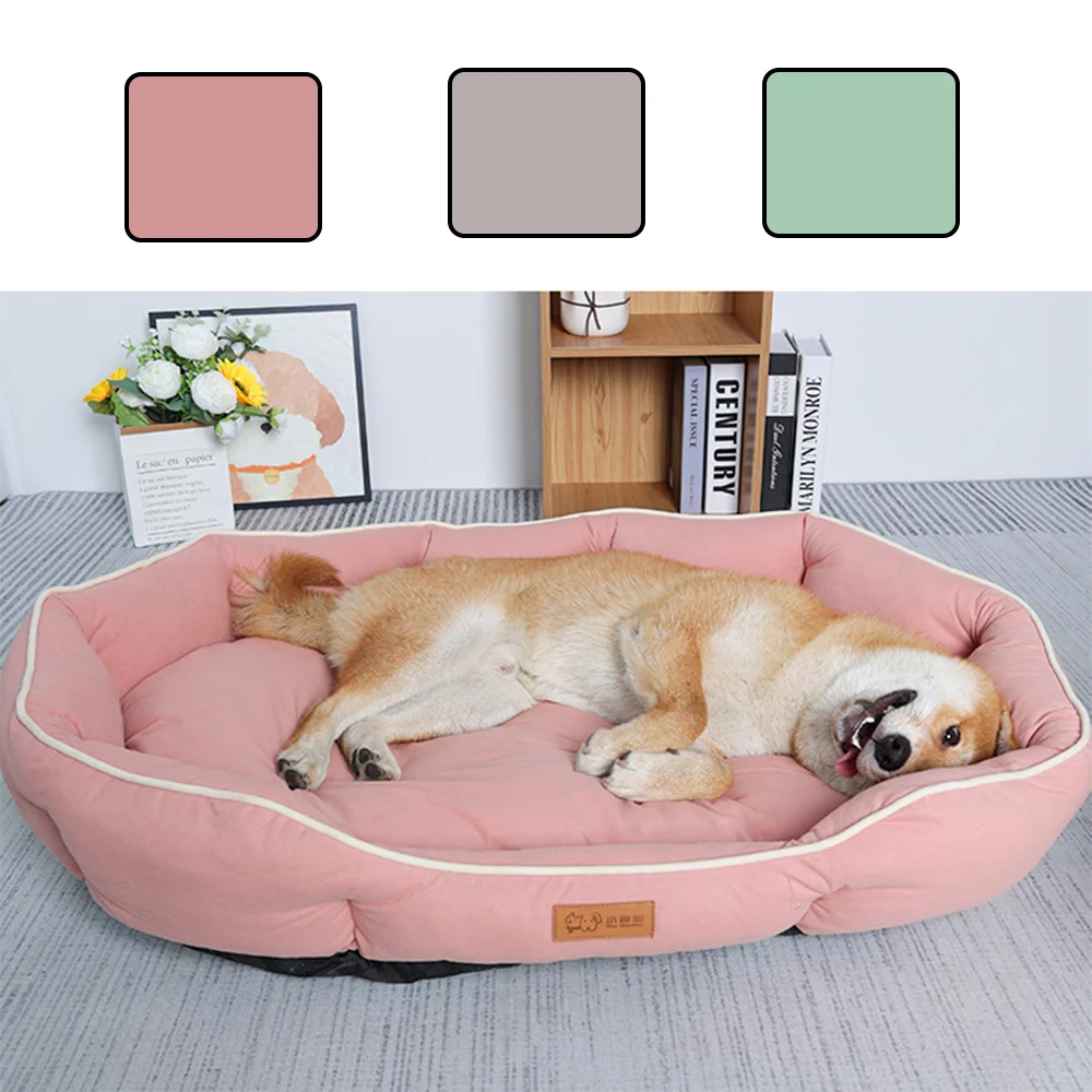 A light pink luxurious corduroy pet sofa bed for dogs and cats resting on a gray carpet.