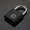 A black biometric fingerprint padlock with a silver shackle and a square indentation.