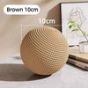 A brown sisal cat toy ball measuring 10cm is shown on a table.
