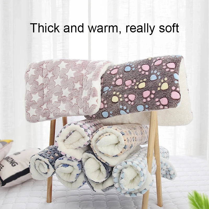 A stack of thick, warm, and soft plaid flannel pet sleeping mats in various colors is displayed on a wooden stand.