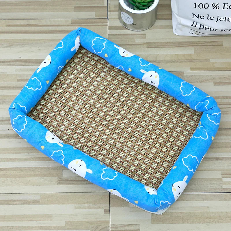 Blue pet bed with a rattan mat featuring white cloud patterns for summer cooling.