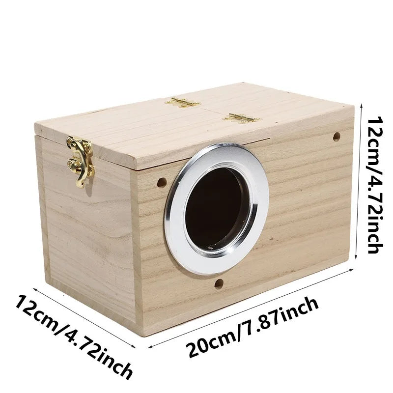 A light wood bird nest box with a circular entrance and a brass latch.