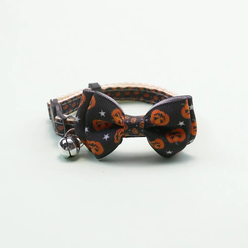 An adjustable Halloween pet collar featuring a black fabric bow tie and a silver bell.