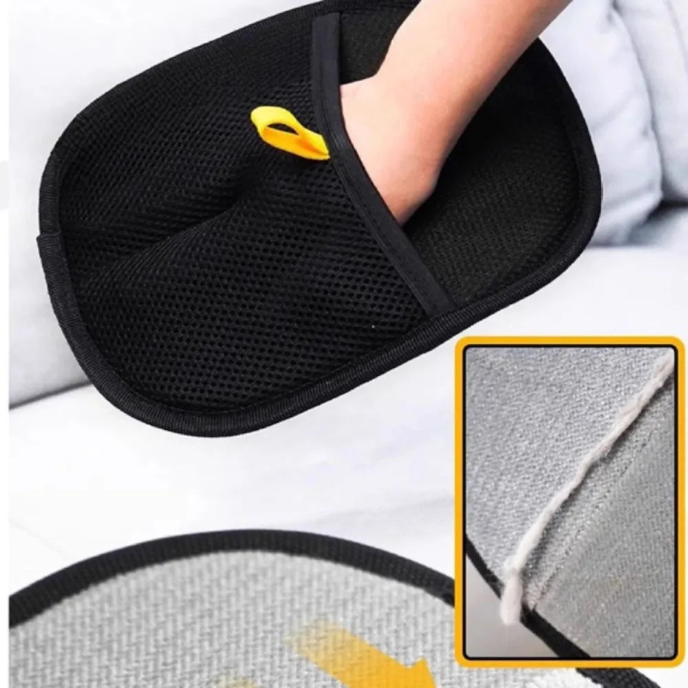 A black pet hair removal grooming glove with a yellow tip is shown being used on a hand.