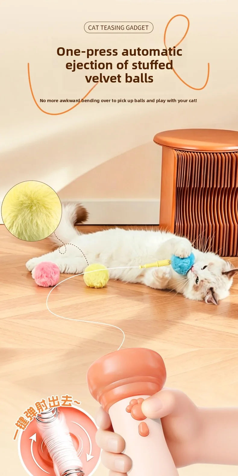 A hand is operating an electric cat teasing gadget to eject stuffed velvet balls from a cat.