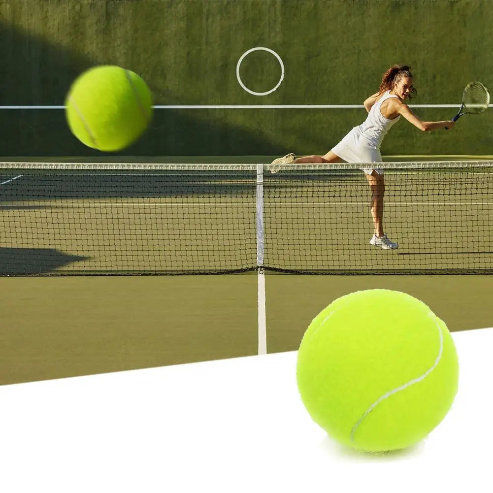 A tennis player is poised to hit a ball over a net, with another tennis ball visible in the foreground.