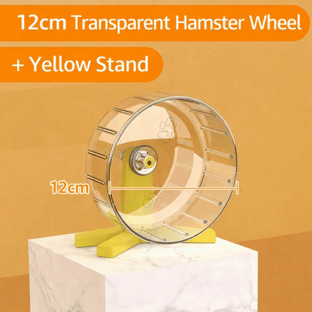 A 12cm transparent hamster wheel mounted on a yellow stand, displayed on a white marble surface.