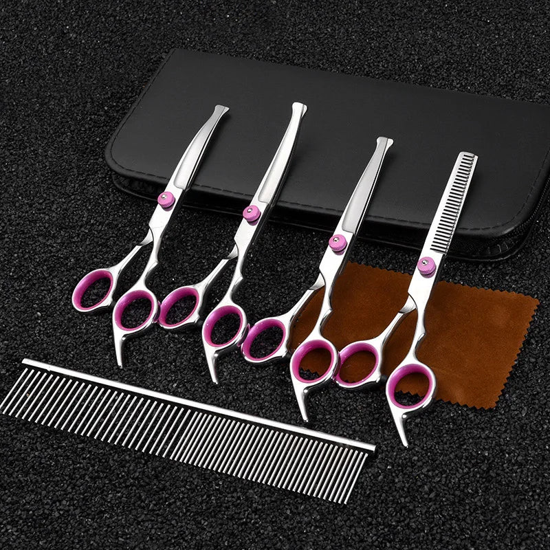 A set of professional stainless steel pet grooming scissors and a comb resting on a black case.