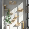 Wall-mounted wooden cat tree and hammock displayed on a white wall with shadows cast by sunlight.