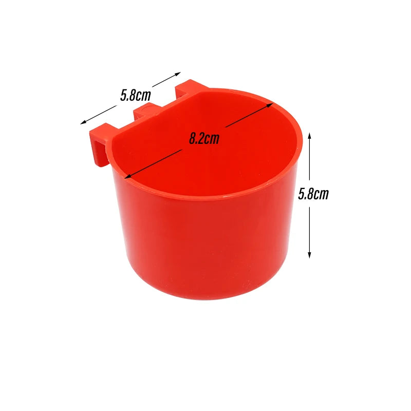 A red plastic bird feeder and water bowl with dimensions marked on the side.