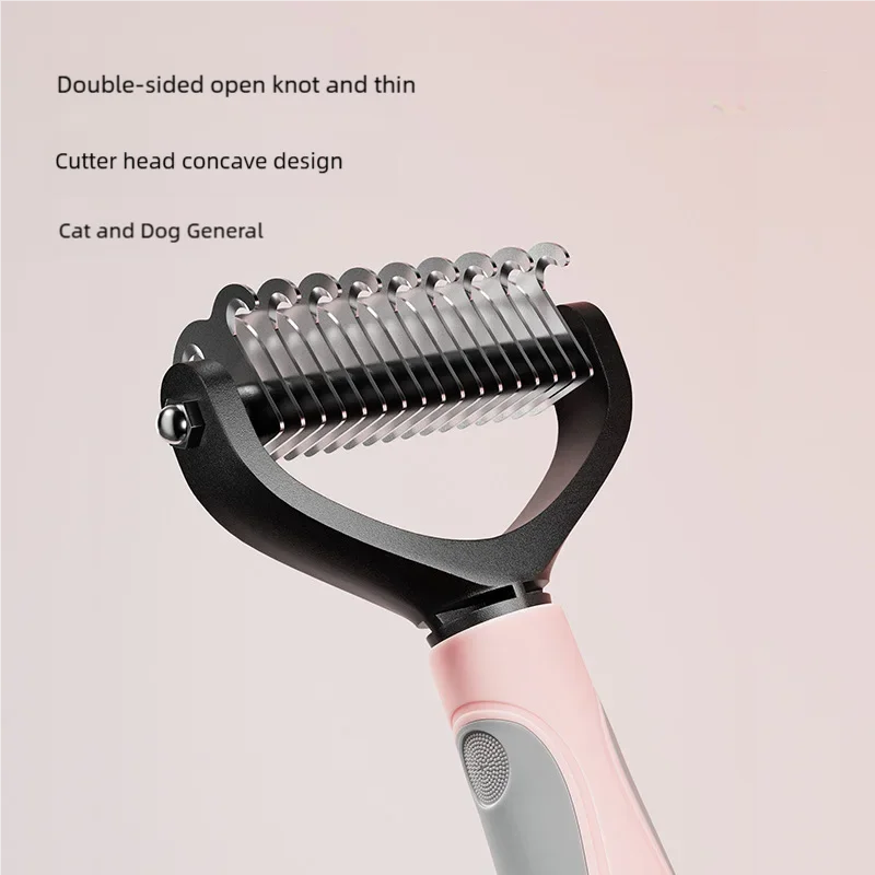 A close-up of a black pet grooming brush with a pink handle, showing the double-sided open knot and thin cutter head design.