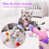 A pink and purple ball launcher is shown being used to stimulate a kitten's hunting nature.