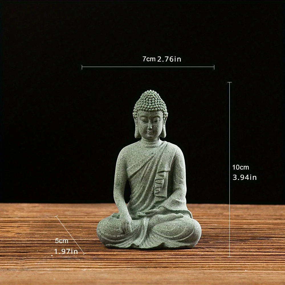 A small, seated Buddha stone statue with a serene expression, displayed on a wooden surface.