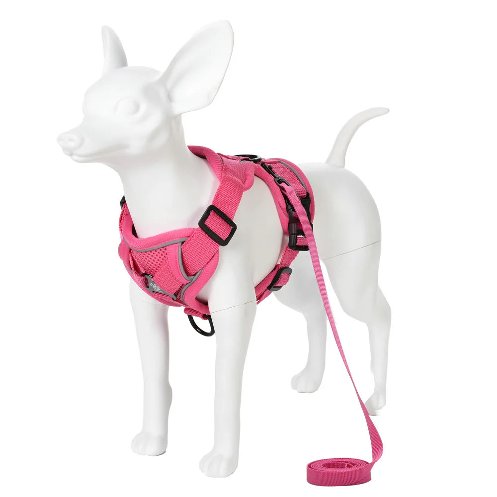 A white dog harness and leash set in bright pink, featuring reflective material.