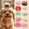A close-up of a light brown dog wearing several pink and green lace hairbows.