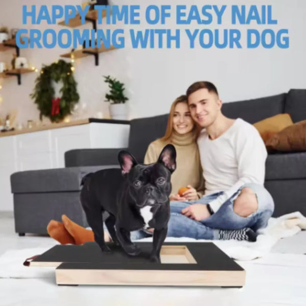 A man and a woman are sitting on a couch with a black dog looking at a wooden pet scratching board.