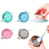 A set of pet food can lids and spoons in various pastel colors including teal, blue, pink, and gray.