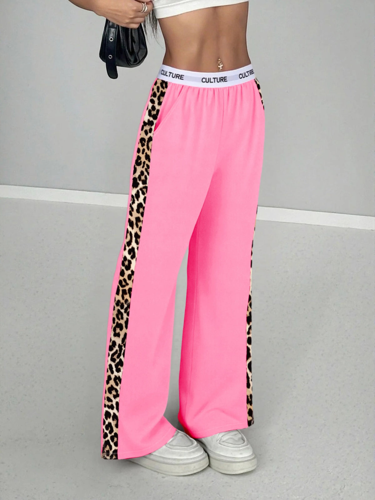 Pink high-waist wide leg pants with black leopard print side stripes and white trim