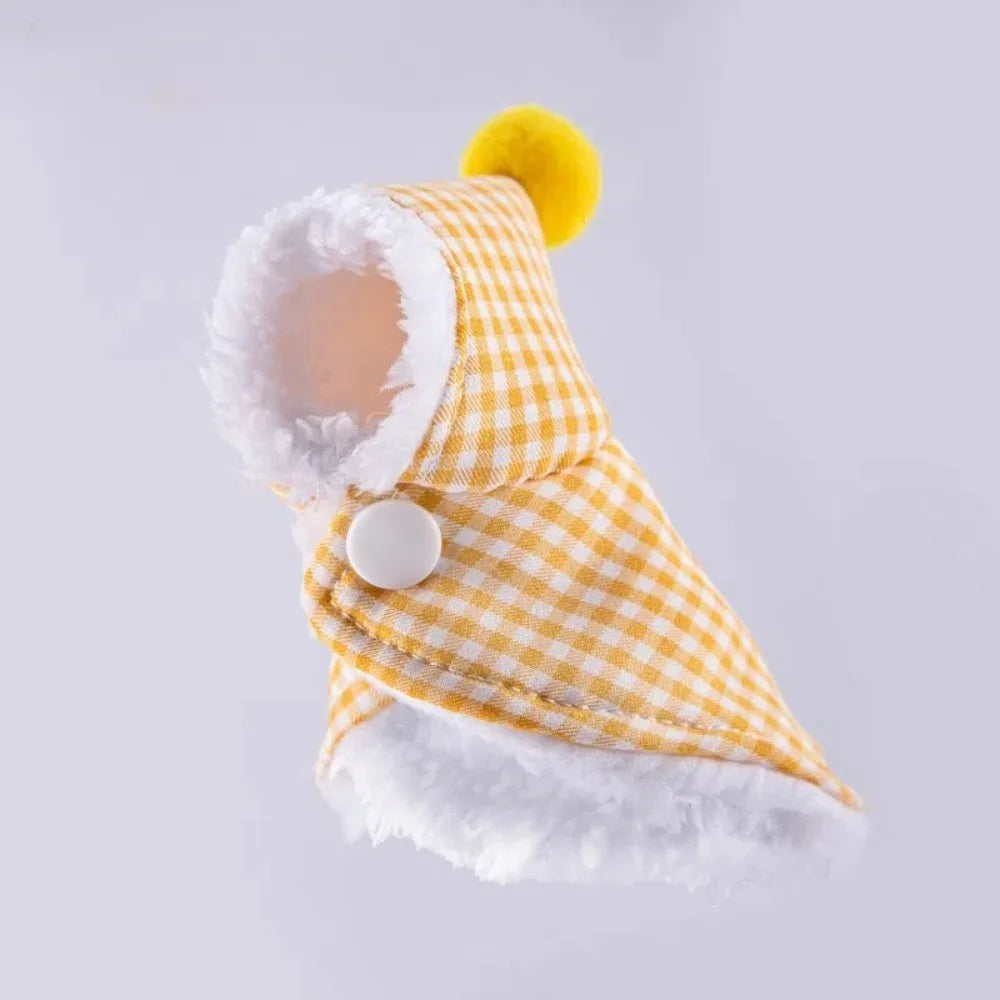A yellow plaid parrot cape and hat set with a fluffy white trim and yellow pom-pom.