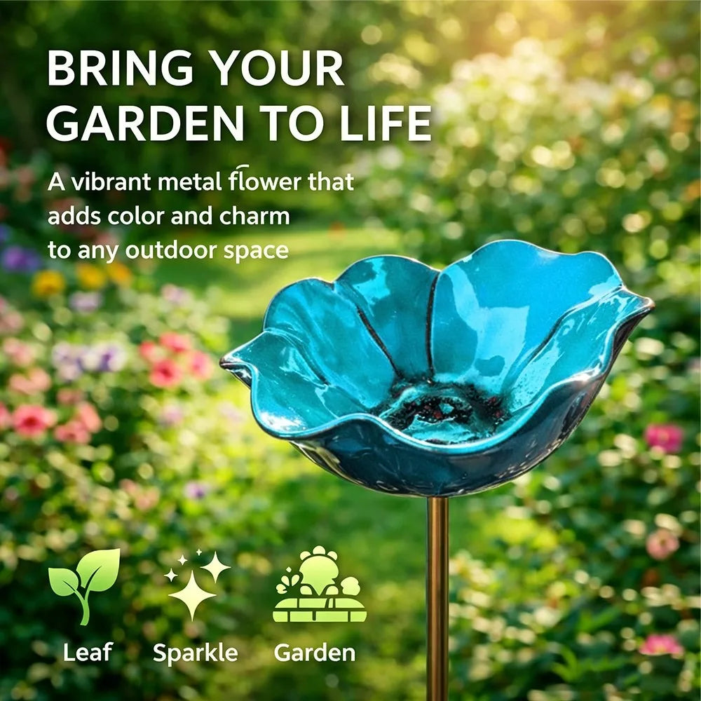 A vibrant blue metal flower shaped outdoor bird bath with a gold stand.
