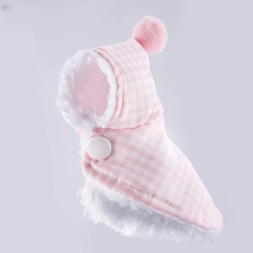 A pink and white plaid parrot cape and hat set with fluffy trim.