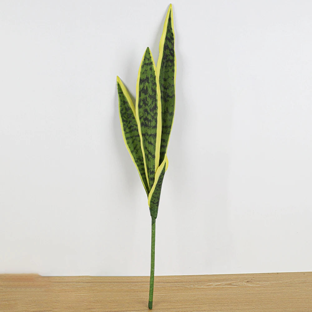 A tall artificial snake plant with long, narrow leaves in shades of green and yellow against a white background.