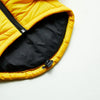 A yellow quilted coat with a black zipper is shown open, revealing the dark lining.