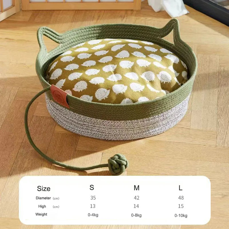 Handwoven rattan cat bed with a green rope edge and a beige cotton interior.
