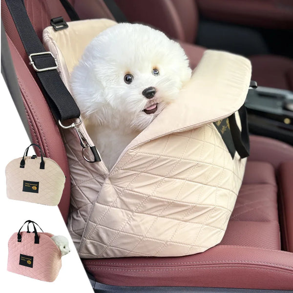 A fluffy white dog is resting inside a light pink quilted portable soft-sided pet carrier placed in a car seat.