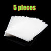 Five sheets of white precision hama beads are displayed on a black surface.