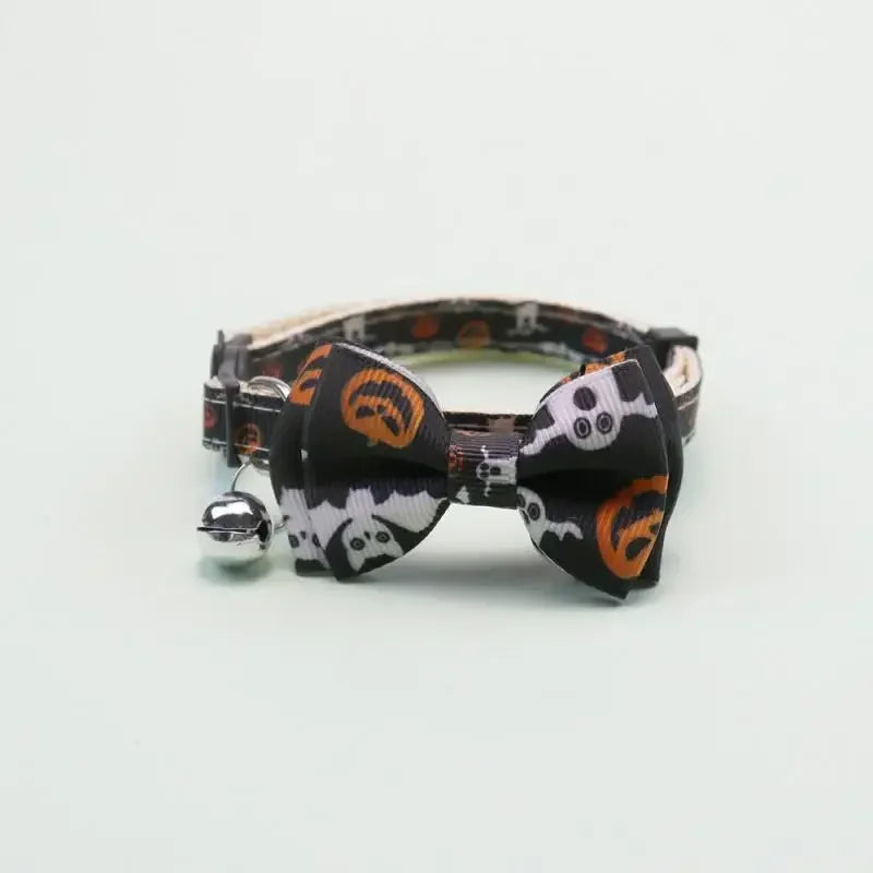Black and orange patterned adjustable pet collar with a bow tie and bell