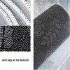 Close-up view of a black and white anti-slip area rug with a floral pattern on the top surface.