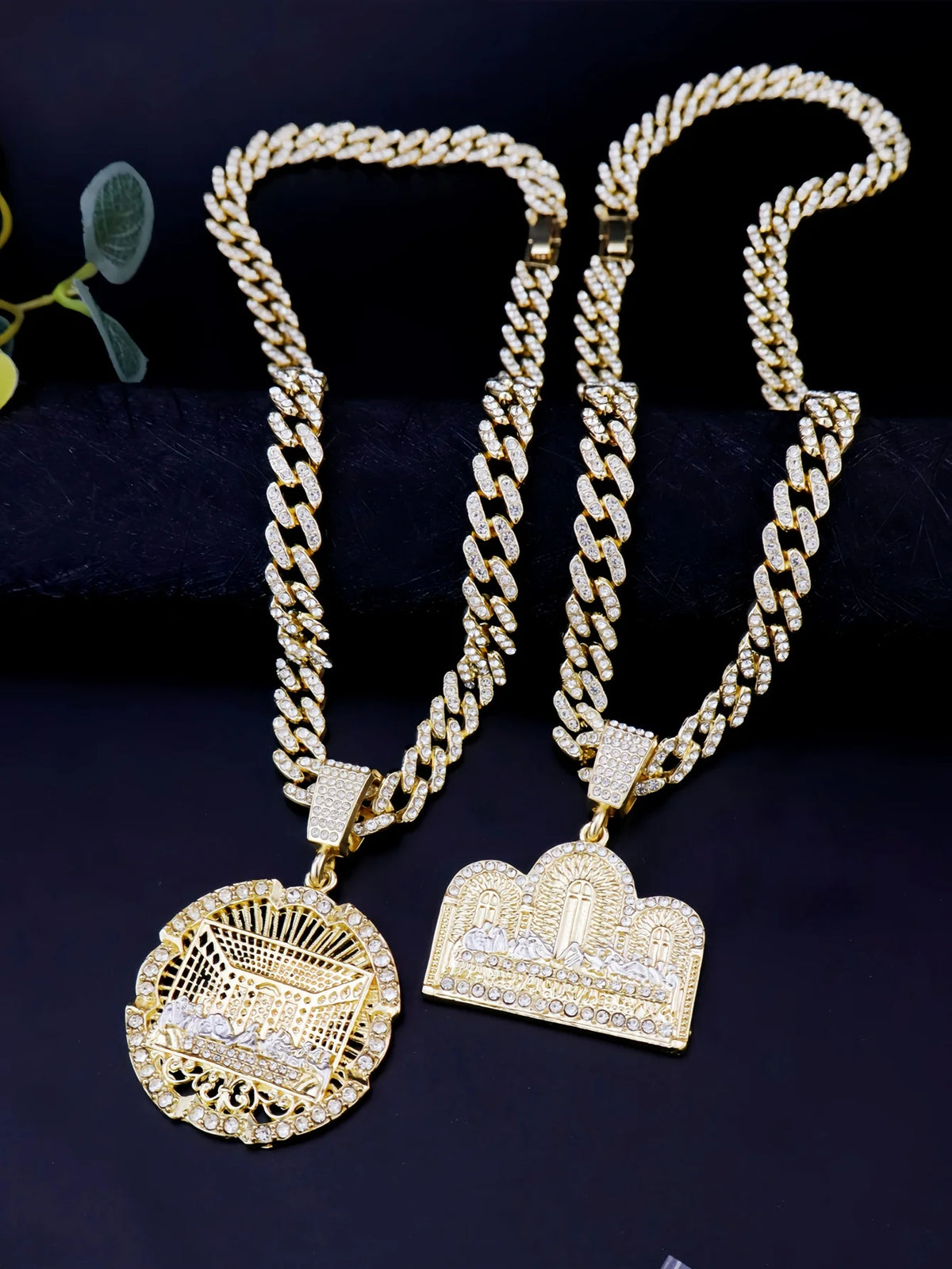 A pair of 14K gold plated last supper medallion necklaces featuring Cuban chains and detailed pendants.