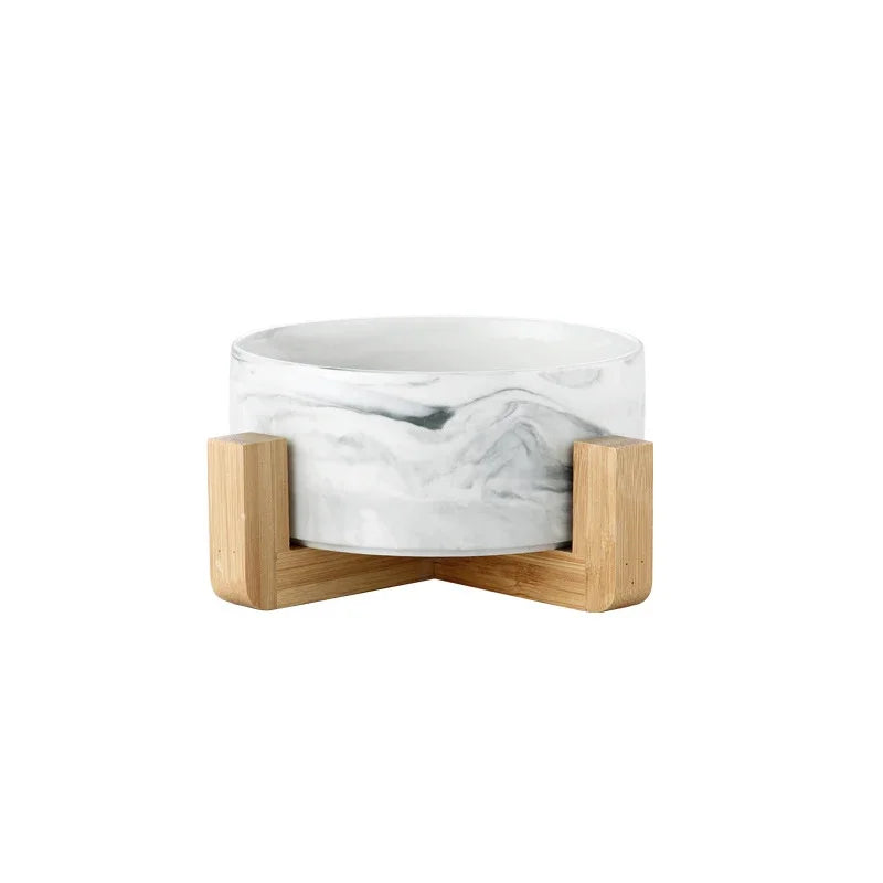 A white marbled ceramic double pet bowl set with a natural wooden stand.