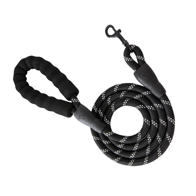 Black reflective dog leash with a padded handle coiled and looped.