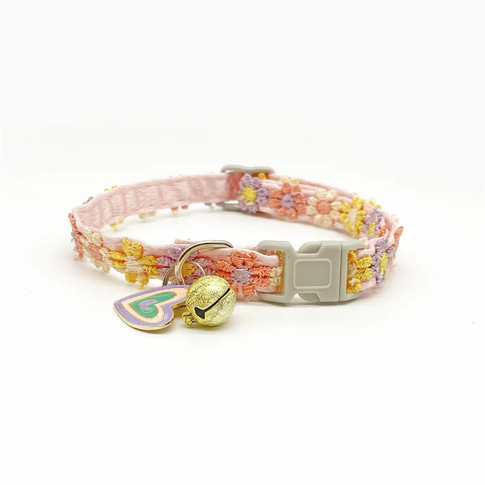 Pink lace flower cat collar with a gold bell and light green tag