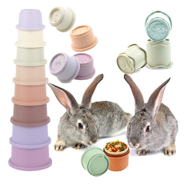 A set of pastel colored stacking puzzle cups and a rabbit interacting with them.