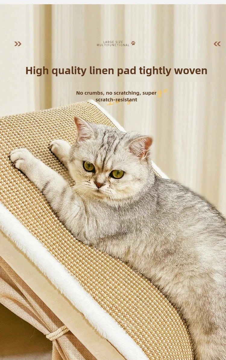 A fluffy gray cat is resting on a woven linen pad inside a wooden cat nest.