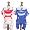 A white and red striped jumpsuit costume for a dog, featuring nautical details.