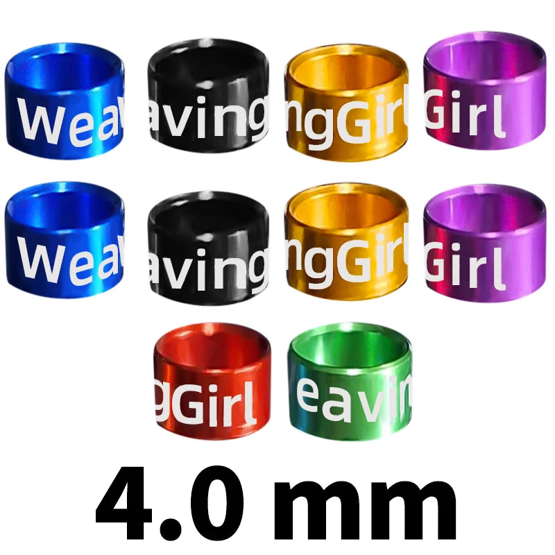 Assorted metal bird identification rings in various colors including blue, black, gold, and purple.