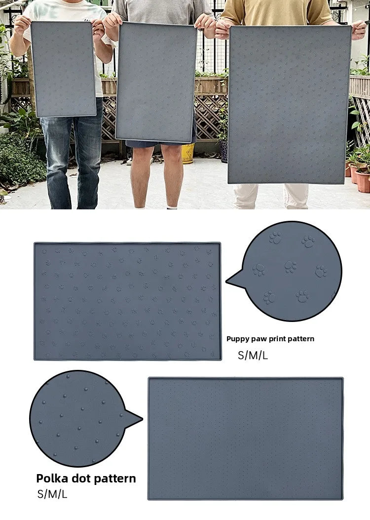 A gray silicone pet feeding mat with various dot and paw print patterns is shown being held by people.