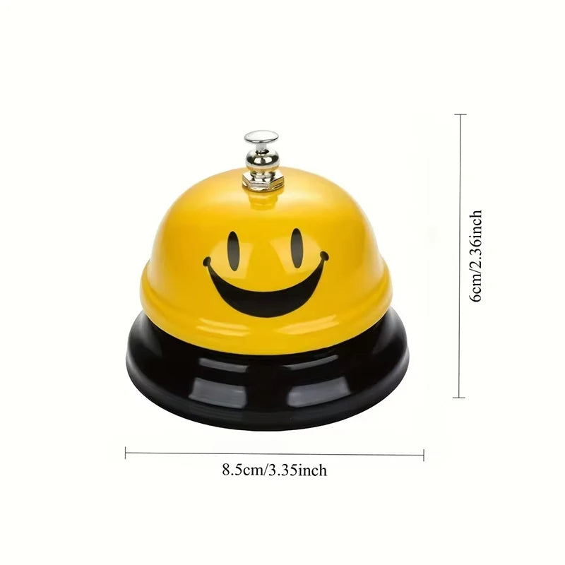 Yellow and black classic brass call bell with a dome shape and a silver top.