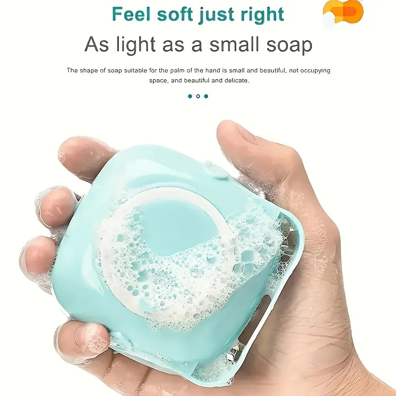 A hand holds a light blue pet bath massage brush with a shower gel dispenser, showing its size and texture.