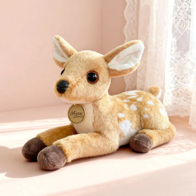 A soft plush stuffed animal toy resembling a fawn or deer with light brown fur and white accents.