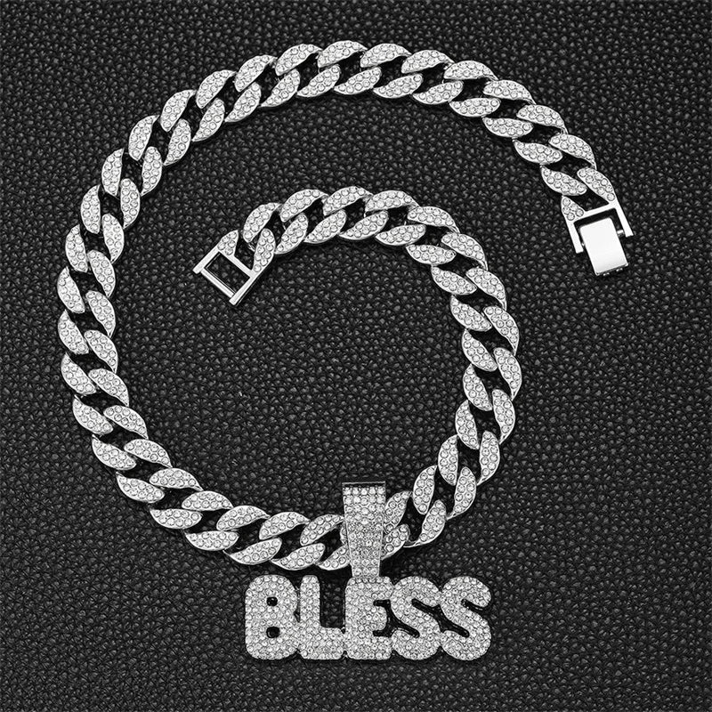 A silver iced out letter and animal pendant Cuban link chain necklace coiled in a circle.