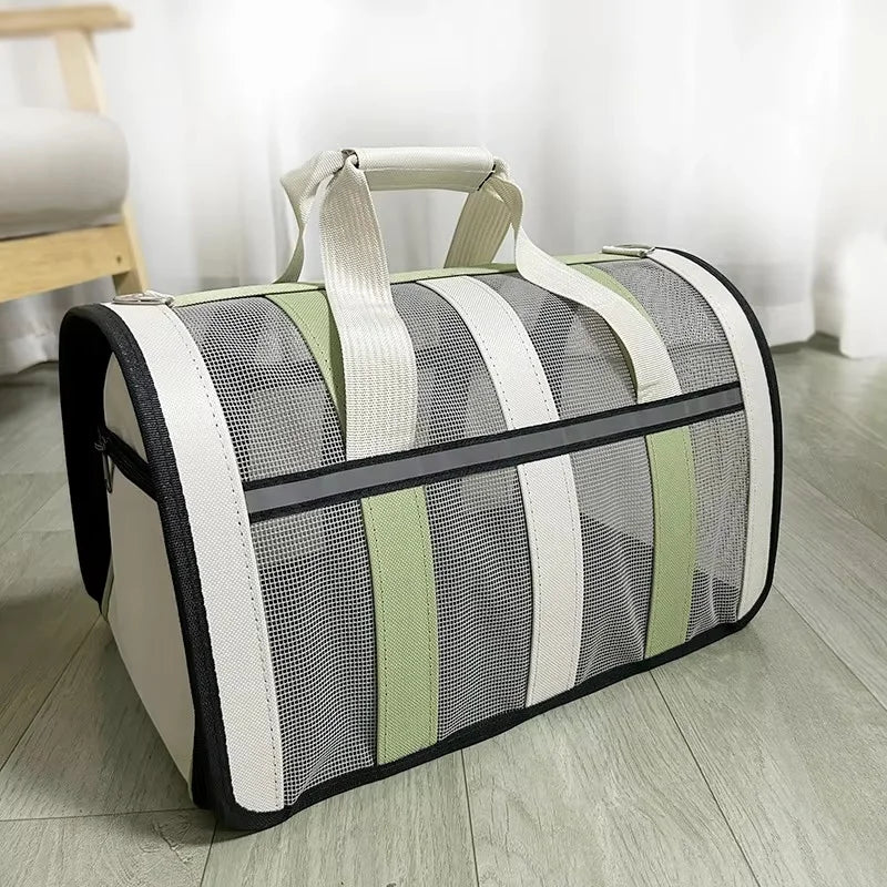 A light-colored mesh travel carrier bag with beige handles and green stripes resting on a wooden floor.