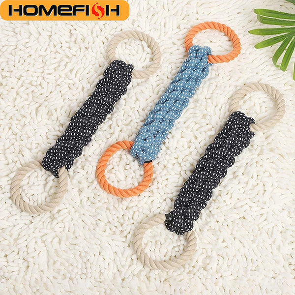 A set of three double-ring cotton rope dog toys in black, blue, and orange colors resting on a white textured surface.