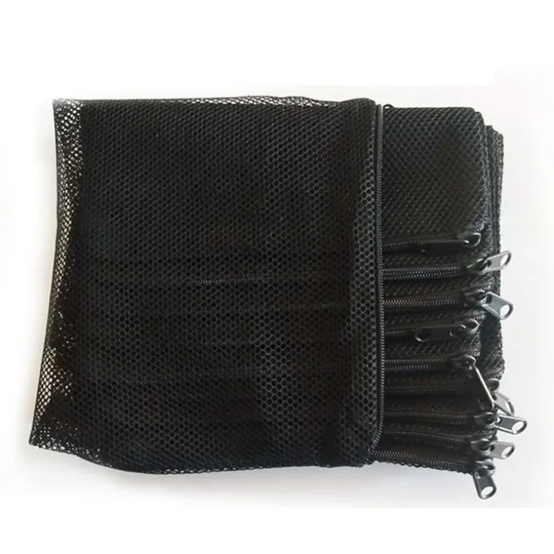 Black mesh bags filled with aquarium filter media, stacked and secured with zippers.