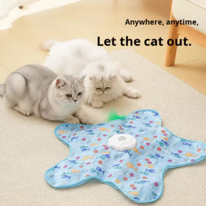 A blue, patterned cat toy is shown with a white cat lying nearby.